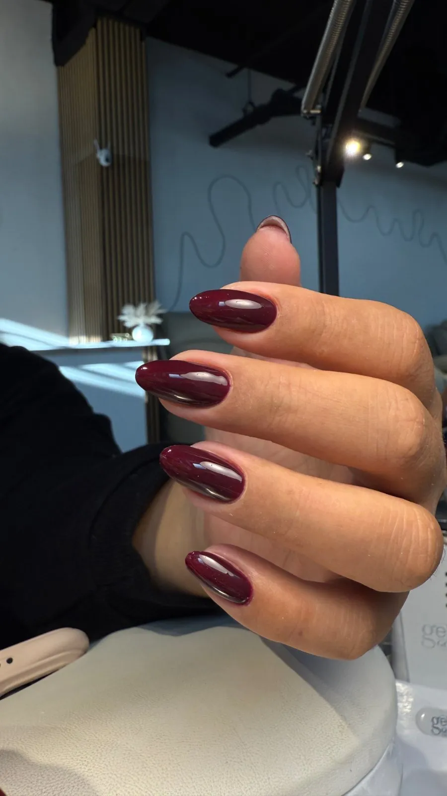 Almond-shaped nails in glossy deep burgundy gel