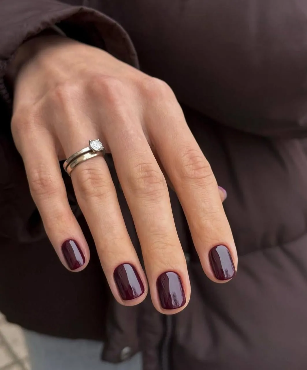 Short rounded nails in glossy deep burgundy polish