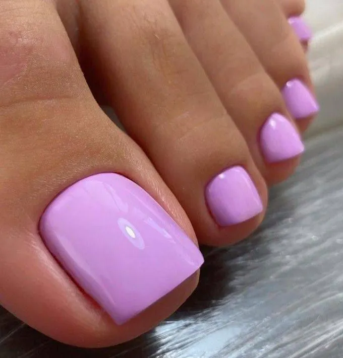 Close-up of a pedicure with glossy lavender polish